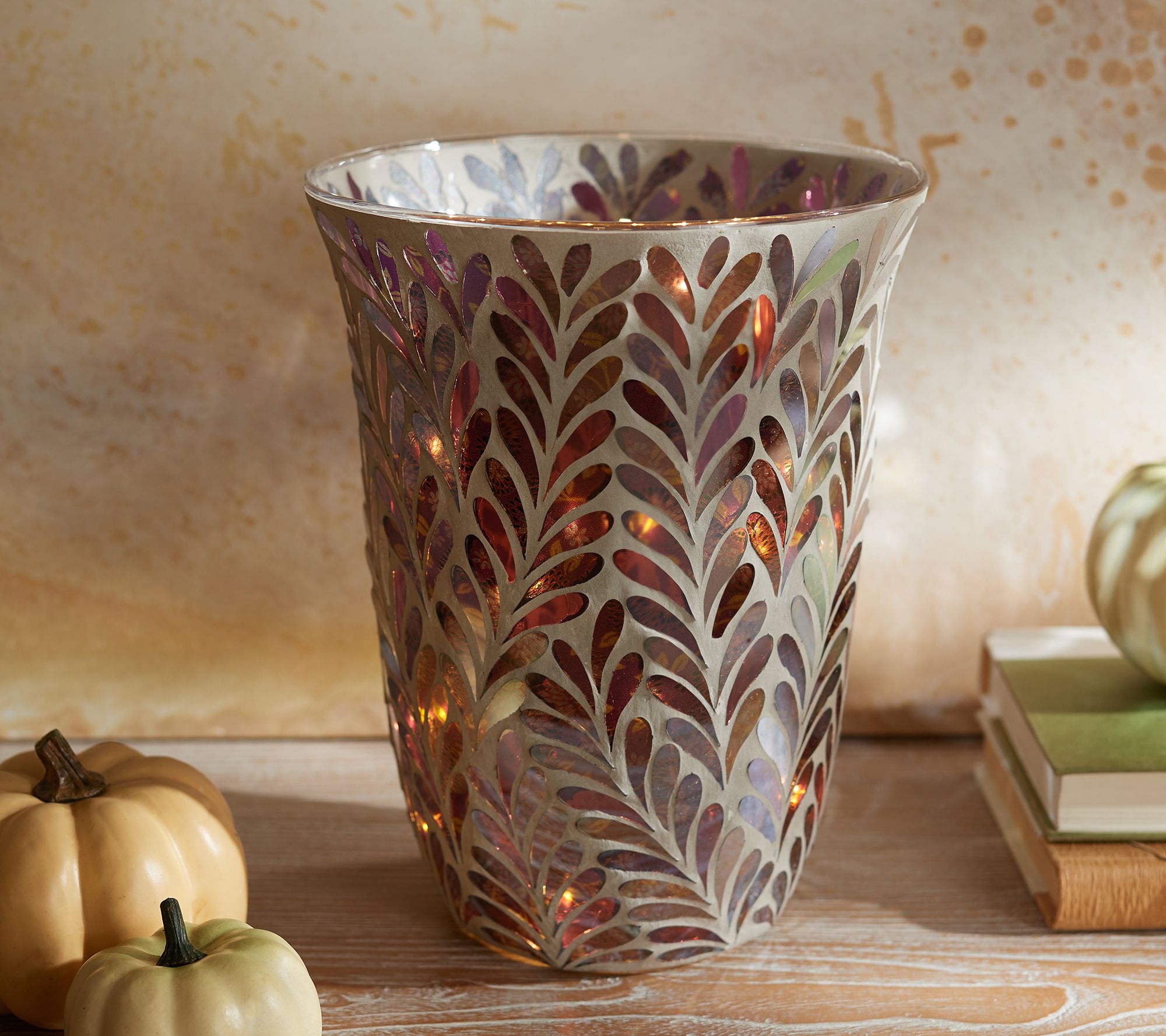 Curved vase with glowing mosaic leaf design