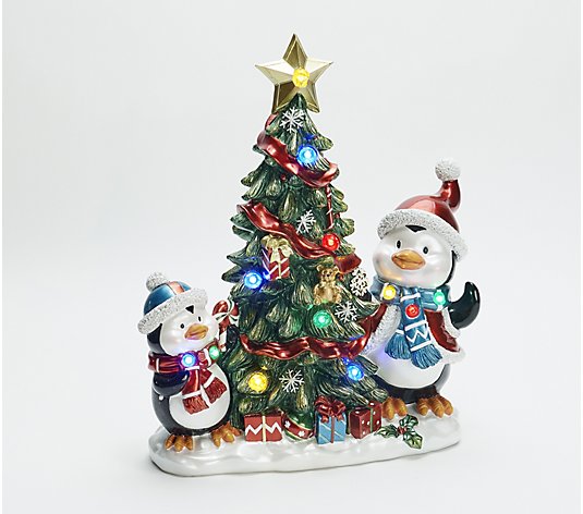 Kringle Express Lit Resin Characters Decorating a Christmas Tree