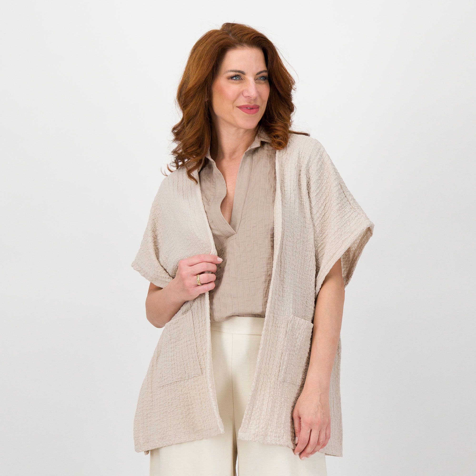 Olly Doo
Poncho con tasche
a maniche a kimono